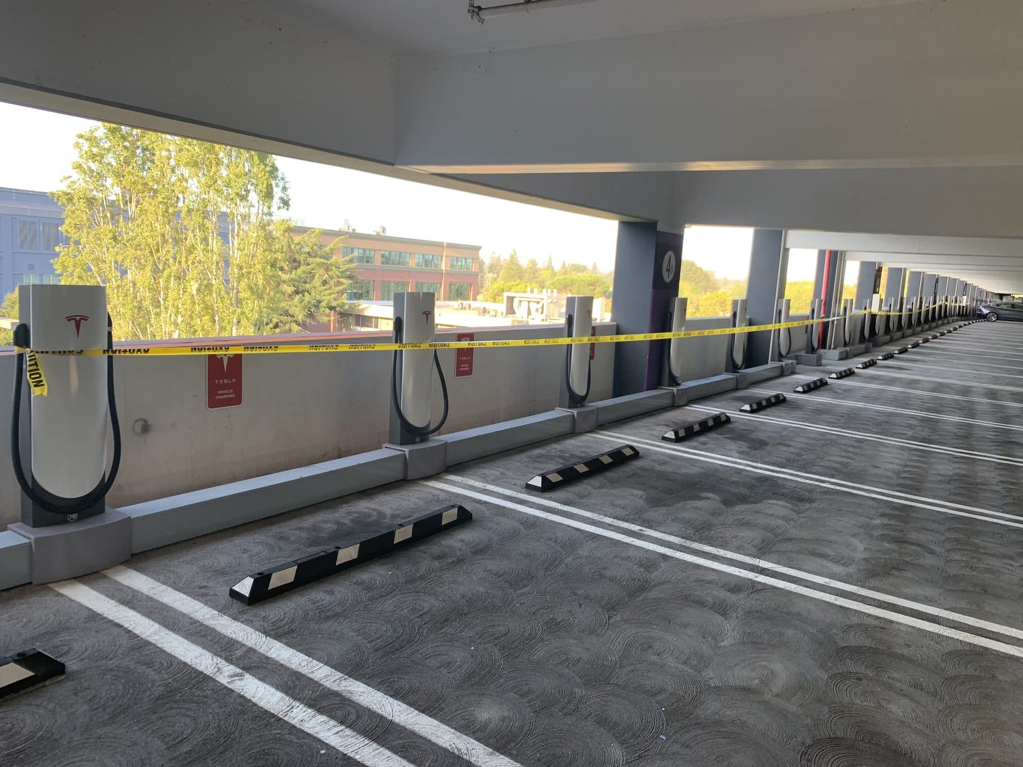Rows of commercial EV charging stations installed in a parking structure